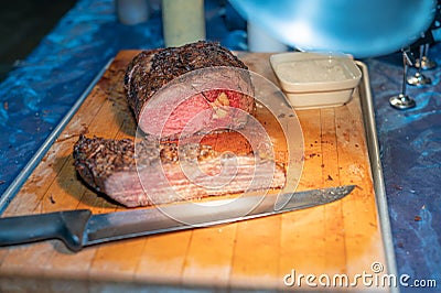 Grassfed prime roast beef on wooden cutting board Stock Photo