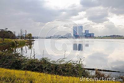 Grassy shore at Lake Xinglong in cloudy winter afternoon Editorial Stock Photo