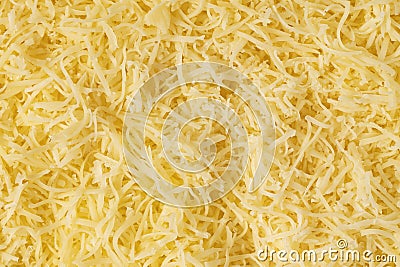 Grated cheese background texture. yellow shredded cheese. Close up top view Stock Photo