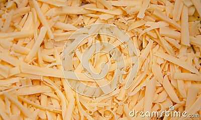 Grated hard cheese for homemade pizza. Russian, Dutch cheese. Grated cheese in macro Stock Photo