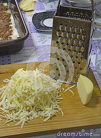 Grated hard cheese in the kitchen Stock Photo