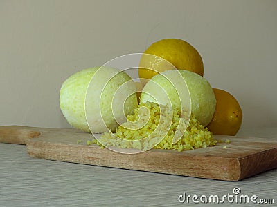 Grated lemon skin. Peeled lemons. Finely grate lemon zest. Juicy ripe yellow lemons. Stock Photo