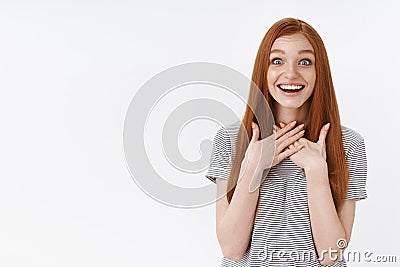 Grateful charming surprised happy smiling redhead girl ginger long hair blue eyes reacting amazed receiving touching Stock Photo