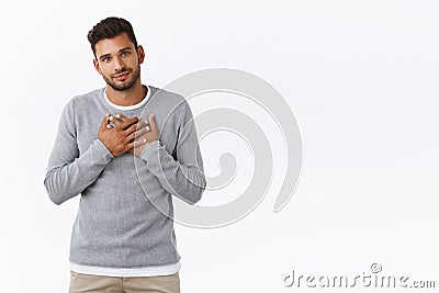 Grateful and pleased handsome cute guy in stylish grey sweater, pleased receive praise, accepting nice offer, hold hands Stock Photo