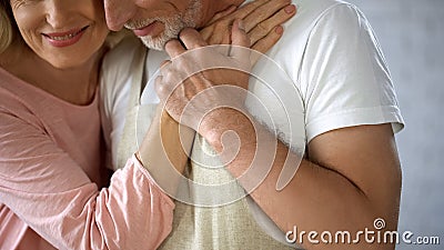 Grateful wife hugging husband, happy marriage, partner help, pensioners love Stock Photo