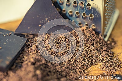 Grater and grated chocolate closeup Stock Photo