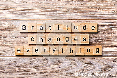 Gratitude changes everything word written on wood block. Gratitude changes everything text on wooden table for your desing, Stock Photo