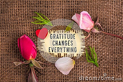 Gratitude changes everything written in hole on the burlap Stock Photo