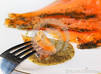 Gravadlax dipped in dill sauce Stock Photo