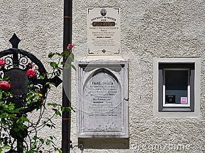 The grave of Franz Gruber, the composer of the song Silent Night, and the facade of his museum house with panels, Hallein, Austria Editorial Stock Photo