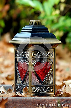 Grave lantern with red hearts of glass Stock Photo