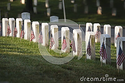 Grave markers with flags at Arlington National Cemetery on Memorial Day Stock Photo