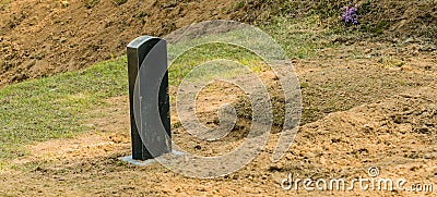 Grave mound with granite marker Stock Photo