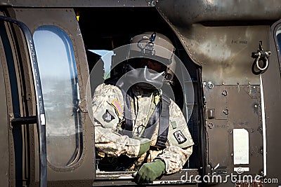 GRAVE, NETHERLANDS - SEP 17: Crew chief in a US Army UH-60 Black Hawk helicopter during the Operation Market Garden Memorial Editorial Stock Photo