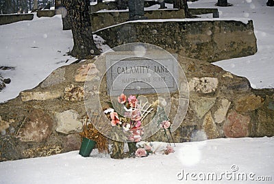 Grave site of Calamity Jane, infamous outlaw in Mount Moriah Cemetery, Deadwood, SD in winter snow Editorial Stock Photo