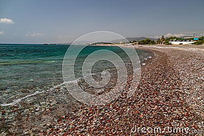 Gravel beach at Kiotari on Rhodes island, Greece Stock Photo