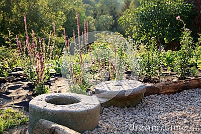 Gravel terrace with patch of perennials. Stock Photo