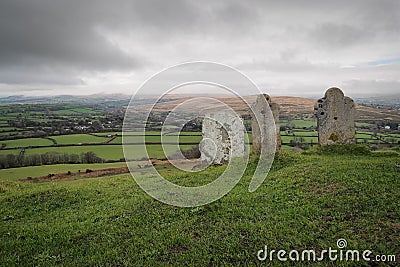 Gravestones at 13th century church St Michael de Rupe, Brent Tor, clouds on hills, Dartmoor National Park, Devon, UK Stock Photo