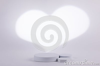 Gray background with a white heart shape behind for product commercial light shape Stock Photo