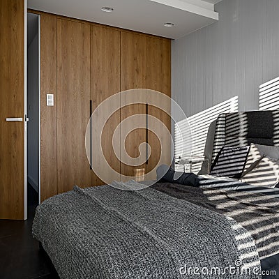 Gray bedroom with wooden closet Stock Photo