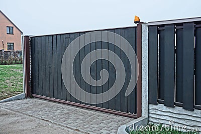 Gray black private gate and wooden plank fence Stock Photo