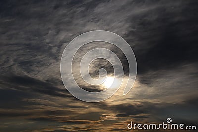 Gray clouds ruthlessly go on the sun, the sun shines because of clouds, a cloud to the sun, soft light of the sun because of a clo Stock Photo