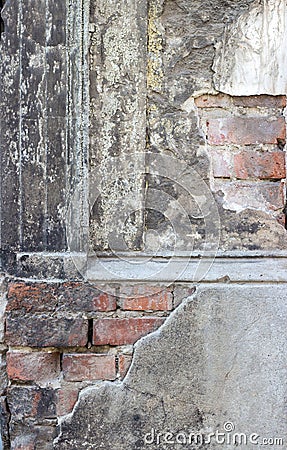 Gray, dilapidated facade with bricks Stock Photo