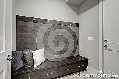 Gray Foyer features Half wood plank accent wall Stock Photo