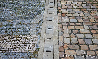 Gray granite cube of small dimensions in combination with quartz brown rectangular tiles. drainage using a hidden gutter under sto Stock Photo