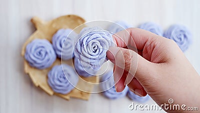 Gray handmade rose flowers on white wood table Stock Photo