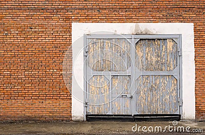 Gray large garage door made of bricks Stock Photo