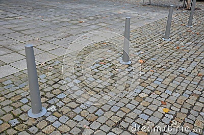 Gray metal bollards are used to protect pedestrians in the pedestrian zone or in the park on the promenade. gray pillars prevent p Stock Photo