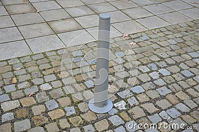 Gray metal bollards are used to protect pedestrians in the pedestrian zone or in the park on the promenade. gray pillars prevent p Stock Photo