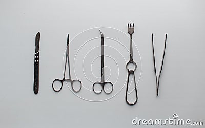 Gray metal medical instruments for neurosurgery on a white table in the operating room. View from above. Stock Photo