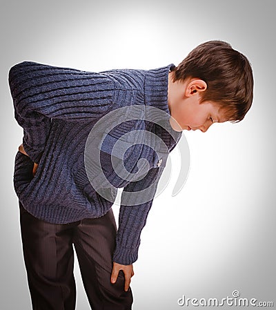 Gray osteochondrosis teenage holds boy teenager his hand behind Stock Photo