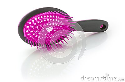 Hairbrush with plastic bristles on a white reflective surface Stock Photo