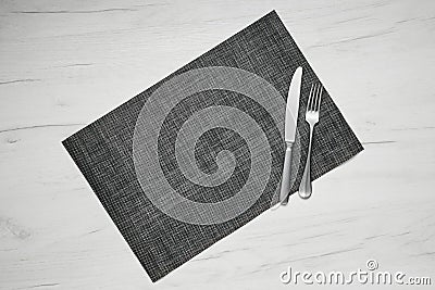 Gray placemat table mat with knife and fork Stock Photo