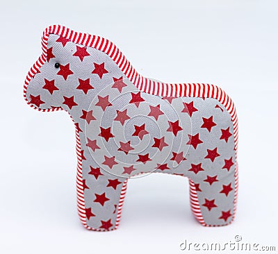 Gray and red textile toy horse with stars and stripes on white Stock Photo