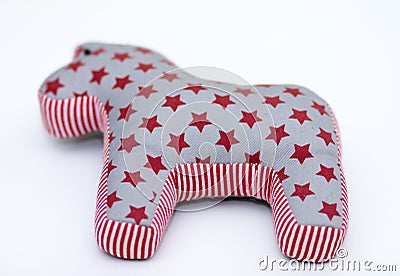 Gray and red textile toy horse with stars and stripes on white Stock Photo