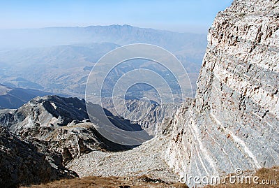 The gray rock on a background of a panorama of the mountains of Tien Shan Stock Photo