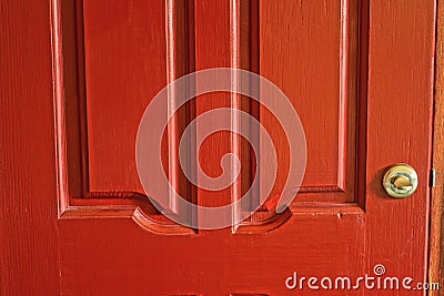 gray round metal doorknob on a red wooden door Stock Photo