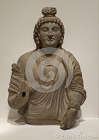 Gray schist stone bust of a Bodhisattva on display in the Dallas Museum of Art in Dallas, Texas. Editorial Stock Photo