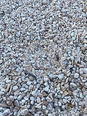 Gray small rocks ground texture. black small road stone background. Stock Photo