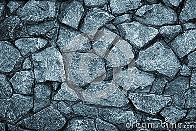 Gray stone wall background. Mosaic of bricks in retro style, modern. Dark rock texture, brick wall pattern. Grey grunge surface Stock Photo