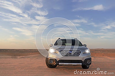 Gray Subaru in the sand of the Namib desert at a bright sky. Walvis Bay, Namibia Editorial Stock Photo