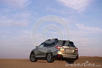 Gray Subaru in the sand of the Namib desert at a bright sunset Editorial Stock Photo