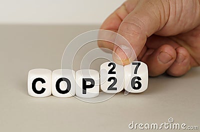 On a gray surface are white cubes with the inscription - COP26 to COP27 Stock Photo