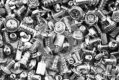 Gray texture background of many randomly scattered computer screws Stock Photo