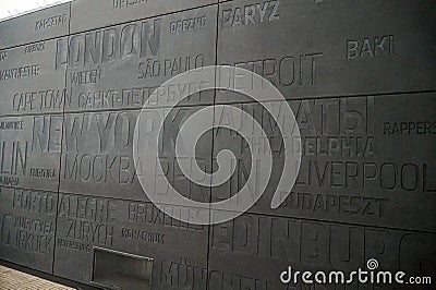 Gray wall with names of cities at the Immigration Museum in the port of Gdynia. Poland. Editorial Stock Photo