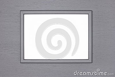 Grey wooden picture frame with blank white poster mock-up on gray painted wood wall. Creative mockup background Stock Photo